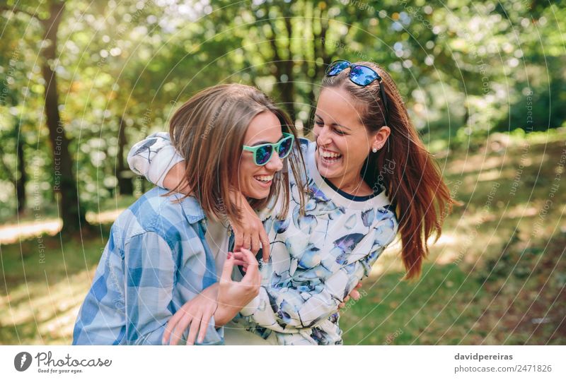 Happy women embracing and laughing over nature background Lifestyle Joy Beautiful Leisure and hobbies Summer Human being Woman Adults Friendship Couple