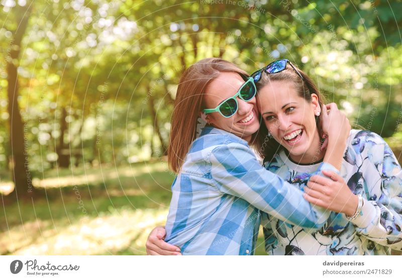 Happy women embracing and having fun over nature background Lifestyle Joy Beautiful Leisure and hobbies Summer Human being Woman Adults Friendship Couple