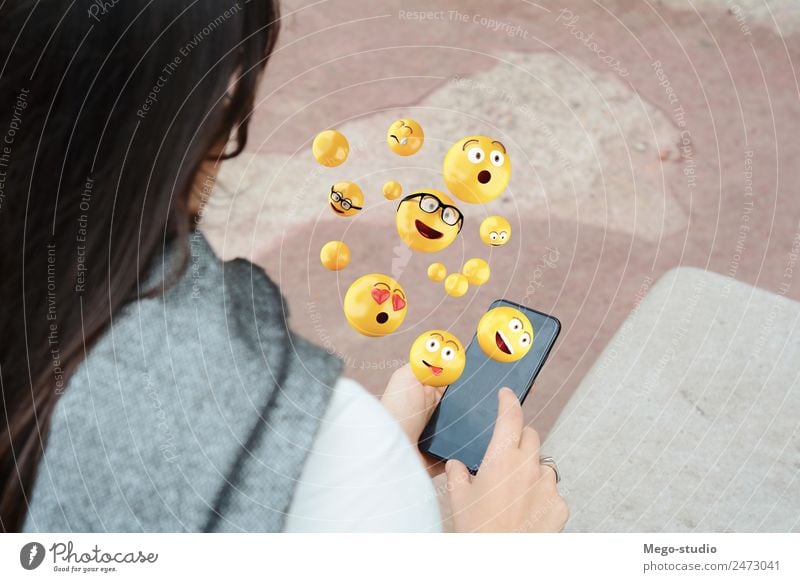 woman using smartphone sending emojis. Lifestyle Happy Face Telephone PDA Screen Technology Internet Human being Woman Adults Hand Funny Modern Smart Emotions