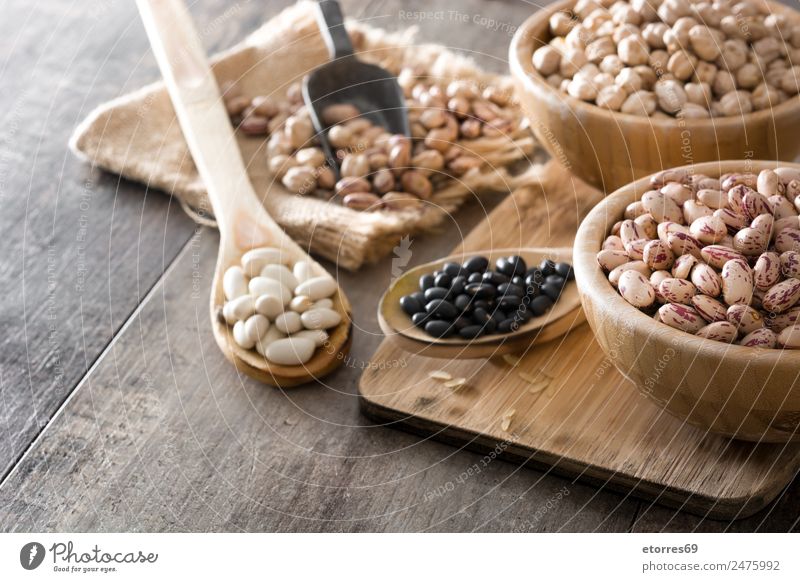 Uncooked assorted legumes in wooden bowl Food Grain Nutrition Eating Organic produce Vegetarian diet Diet Bowl Spoon Natural Brown Legume Mix Beans Chickpeas