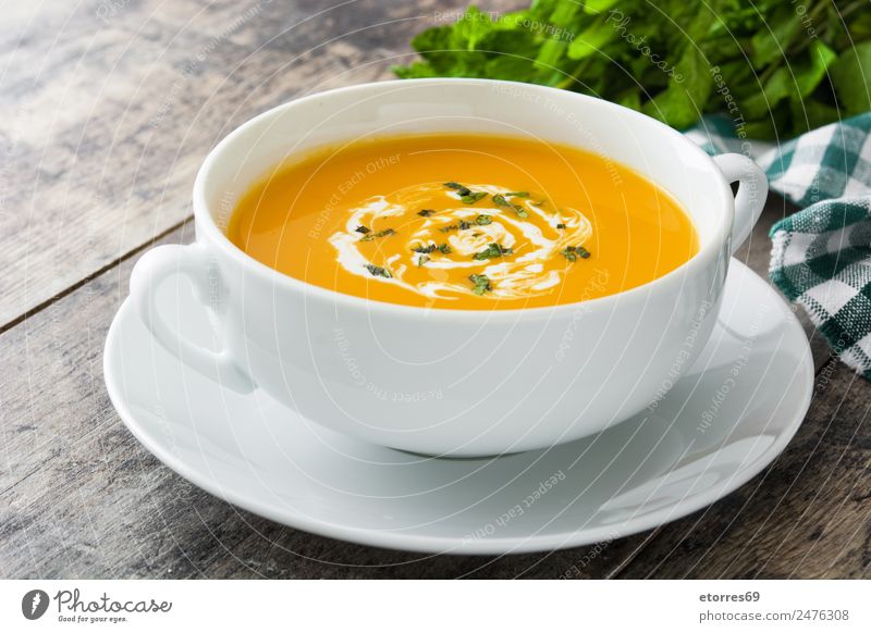 Pumpkin soup in white bowl Food Vegetable Soup Stew Nutrition Organic produce Vegetarian diet Diet Hot drink Bowl Spoon Hallowe'en Natural Green Orange White
