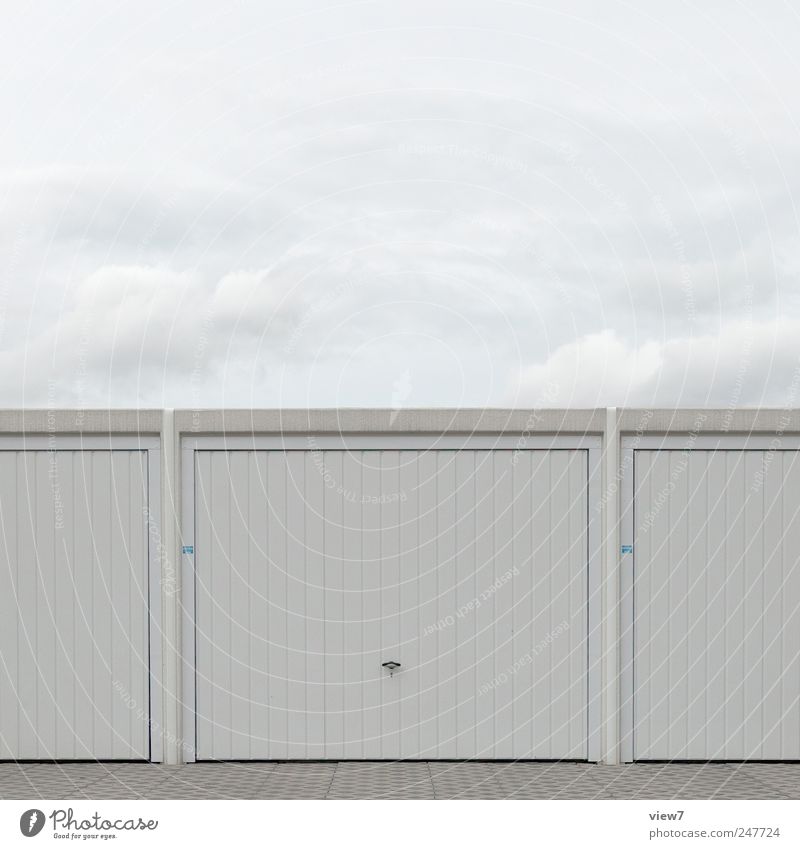 garage Nature Sky Clouds Weather Industrial plant Manmade structures Building Wall (barrier) Wall (building) Facade Door Roof Stone Concrete Metal Line Stripe