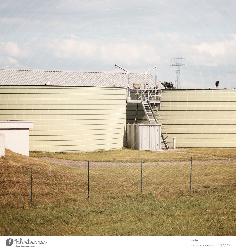 sewage treatment plant Sky Meadow Industrial plant Manmade structures Building Gloomy Blue Yellow White Sewage plant Silo Colour photo Exterior shot Deserted