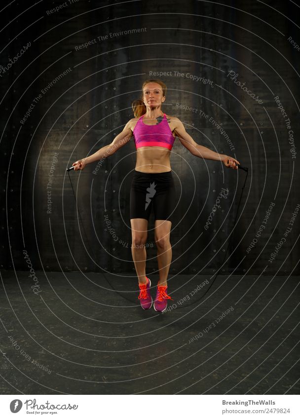 Full-length Side Portrait of the Young Athletic Woman in Black