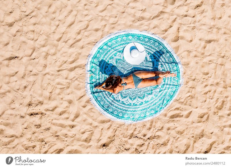 Top Aerial Drone View Of Woman In Swimsuit Bikini Relaxing And Sunbathing On Round Turquoise Beach Towel Near The Ocean Vantage point Aircraft Summer