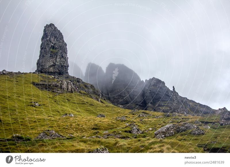 Old Man of Storr on the Isle of Skye in Scotland Landscape Autumn Climate Weather Bad weather Fog Grass Meadow Hill Rock Mountain Peak Green Wall of rock