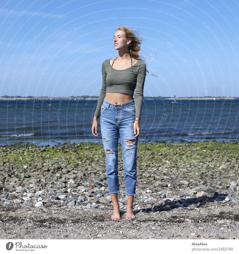 Young woman standing with closed eyes at the Baltic Sea beach Lifestyle pretty Body Wellness Harmonious Summer Summer vacation Sun Sunbathing Beach Ocean