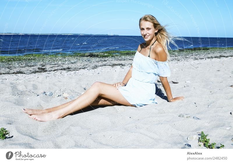 Young, slender, long-legged woman on a Baltic beach in a summer dress Lifestyle pretty Well-being Summer Summer vacation Sun Sunbathing Beach Ocean Young woman