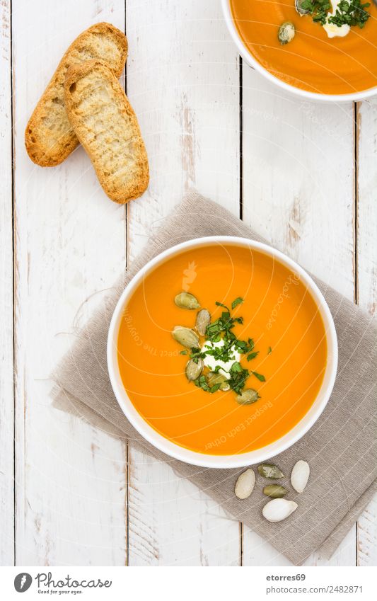 Pumpkin soup in white bowl on white wooden table Food Vegetable Soup Stew Nutrition Organic produce Vegetarian diet Bowl Healthy Health care Healthy Eating