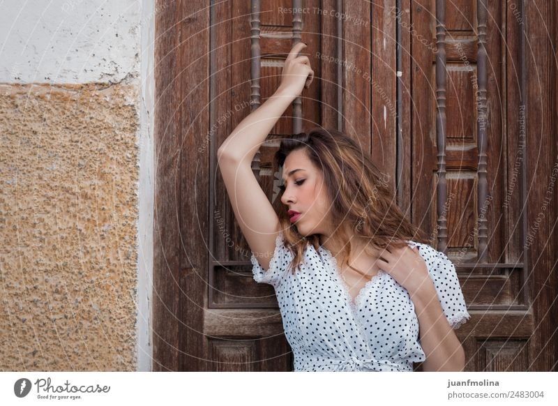 Thoughtful Woman Next To A Door A Royalty Free Stock Photo