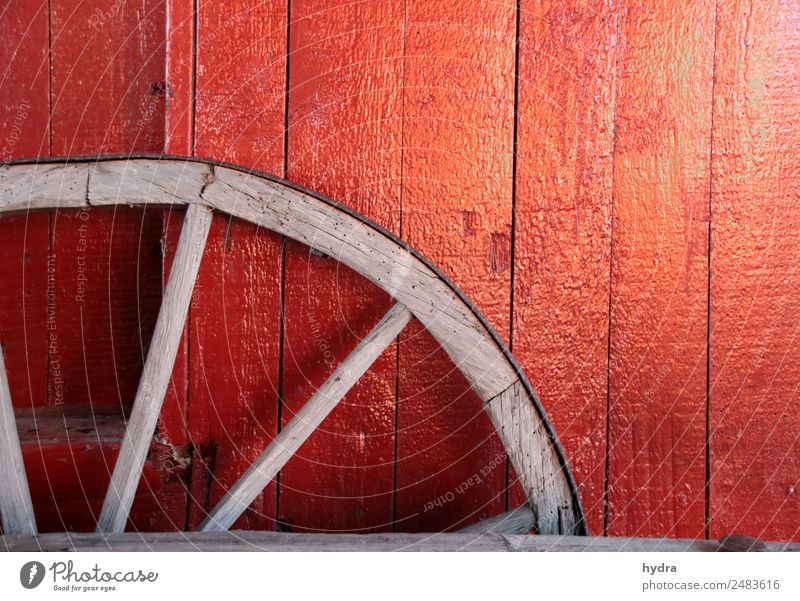 Old wagon wheel in front of red wooden wall in shed Agriculture Forestry Village Fishing village hut Wall (barrier) Wall (building) Chauffeur