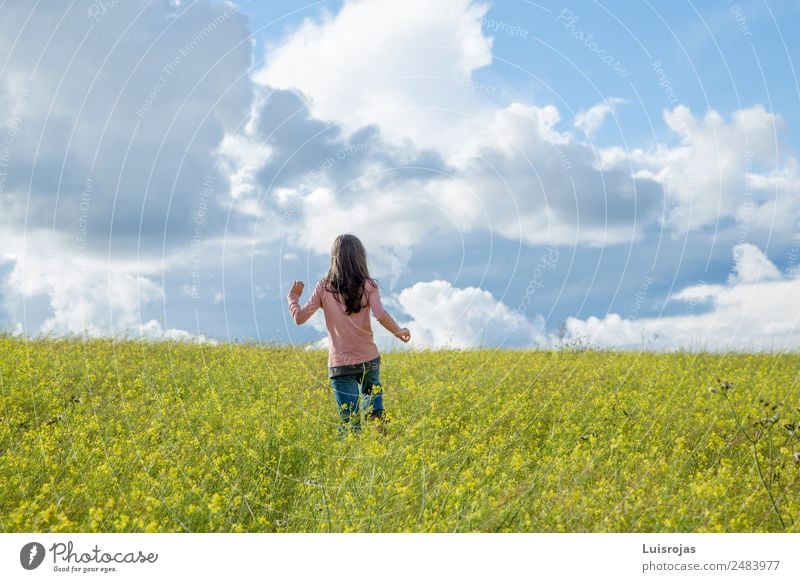girl walking in a field with yellow flowers sunny day Healthy Relaxation Freedom Summer Feminine Girl 1 Human being 3 - 8 years Child Infancy 8 - 13 years