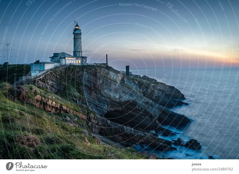 Lighthouse on a rocky coast by the sea Nature Ocean Exterior shot Water Sky Landscape Colour photo Deserted Landmark Tourist Attraction