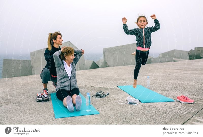 Girl jumping while women train Bottle Lifestyle Happy Wellness Sports Child Telephone Human being Woman Adults Mother Grandmother Family & Relations Fog