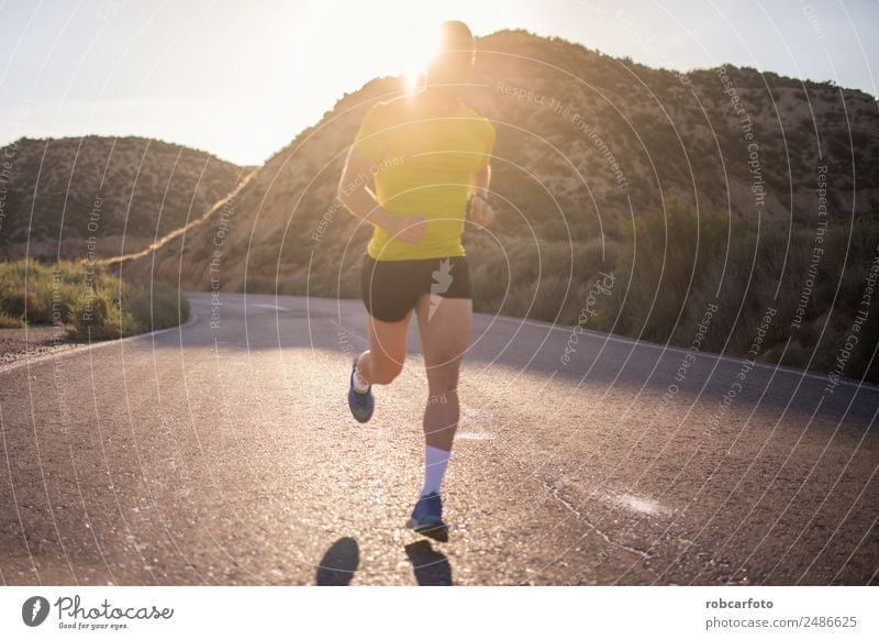 Young man running with greenish yellow shirt Lifestyle Sun Sports Jogging Human being Man Adults Park Bridge Movement Fitness Athletic Speed White young healthy