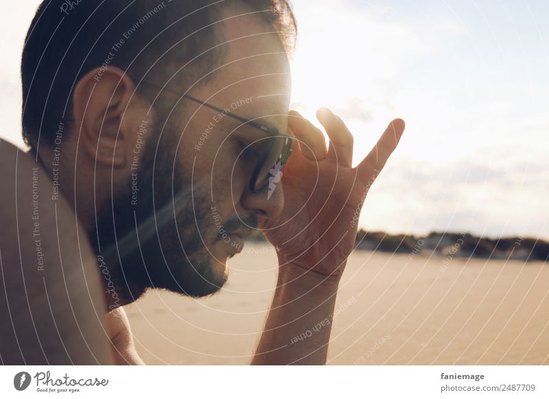 Ray of Light Human being Masculine Hair and hairstyles Face 1 Think Camargue Sunbathing Warmth Sand Beach Sunglasses Hand Gesture Relaxation Reading