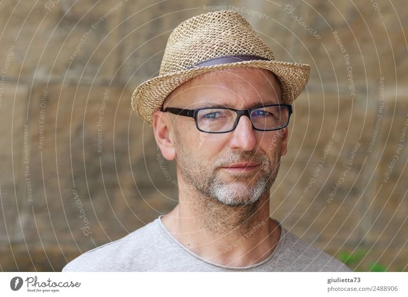 Portrait of man with grey beard wearing spectacles and hat stock photo