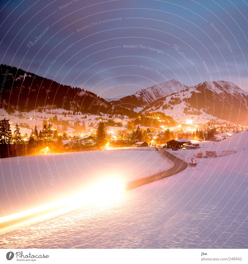 View to Gstaad Tourism Winter Snow Winter vacation Mountain Nature Clouds Alps Snowcapped peak Traffic infrastructure Passenger traffic Car headlights Movement