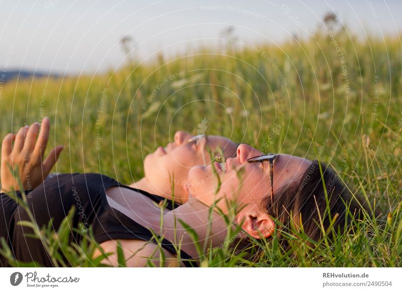 2 young women lying on the meadow Lifestyle Well-being Relaxation Calm Leisure and hobbies Human being Feminine Young woman Youth (Young adults) Woman Adults