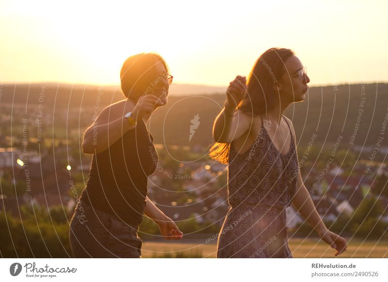 2 young women dancing in the evening sun Lifestyle Joy Happy Harmonious Well-being Leisure and hobbies Vacation & Travel Human being Feminine Young woman