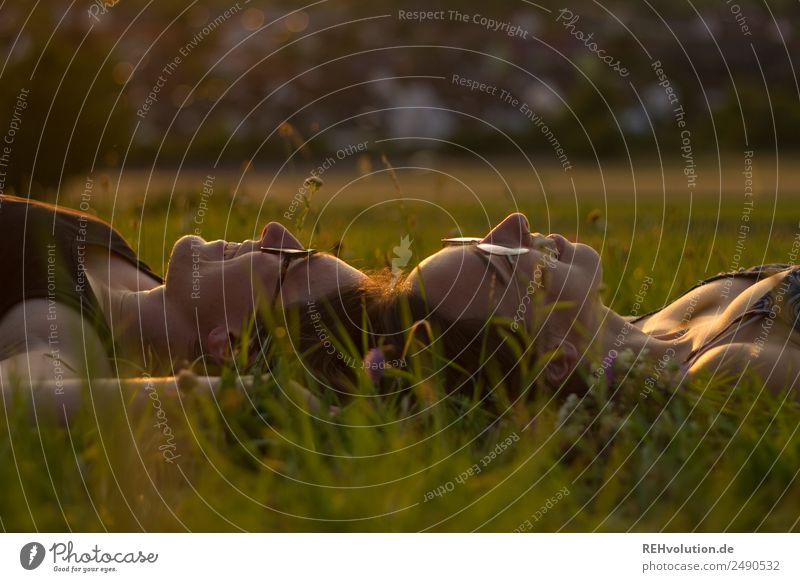 2 young women lying on the meadow Lifestyle Joy Happy Harmonious Well-being Contentment Relaxation Calm Leisure and hobbies Human being Feminine Young woman