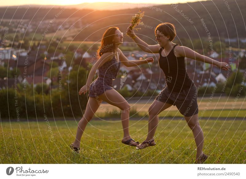Two women dancing across the meadow Young woman Adults Brothers and sisters 30 - 45 years 18 - 30 years Friendship Sister Contentment Joy naturally Together