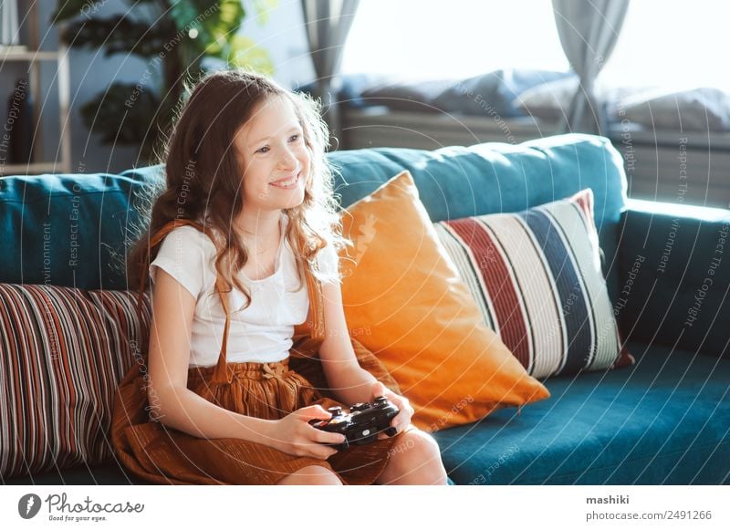 happy child playing video games with gamepad at home Lifestyle Joy Leisure and hobbies Playing Flat (apartment) Entertainment Success Child Schoolchild Computer