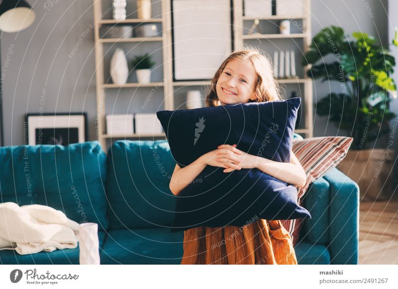 happy cheerful kid girl posing with pillow Lifestyle Happy Flat (apartment) House (Residential Structure) Moving (to change residence) Decoration Living room