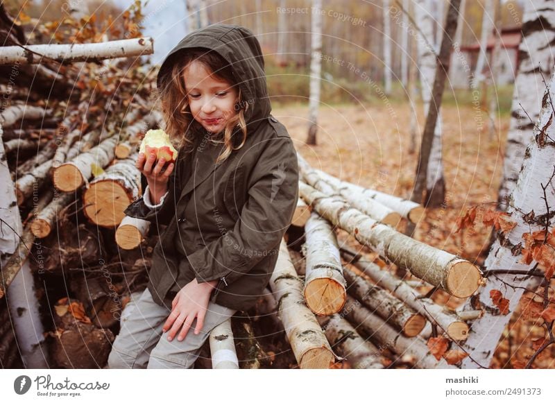 happy funny kid girl eating fresh apple in autumn Fruit Apple Lifestyle Joy Happy Playing Garden Child Infancy Nature Autumn Warmth Leaf Forest Scarf Smiling