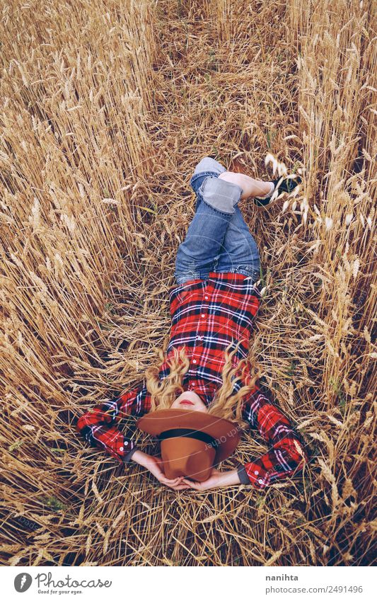 Young woman resting in a field of wheat Grain Organic produce Lifestyle Style Wellness Relaxation Leisure and hobbies Vacation & Travel Freedom Summer