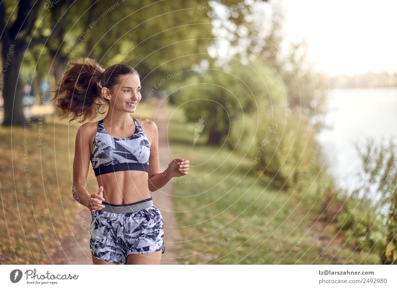 Fit healthy athletic woman jogging on a river bank Lifestyle Happy Summer Sports Jogging Woman Adults 1 Human being 18 - 30 years Youth (Young adults) Warmth