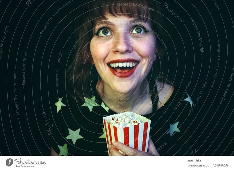 Cheerful young woman watching a movie Food Popcorn Lifestyle Style Wellness Leisure and hobbies Entertainment Going out Human being Feminine Young woman