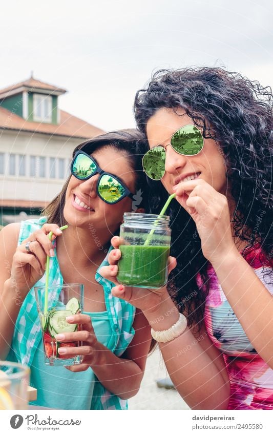 Two women with sunglasses drinking organic beverages outdoors Vegetable Fruit Nutrition Diet Beverage Juice Lifestyle Happy Summer Human being Woman Adults