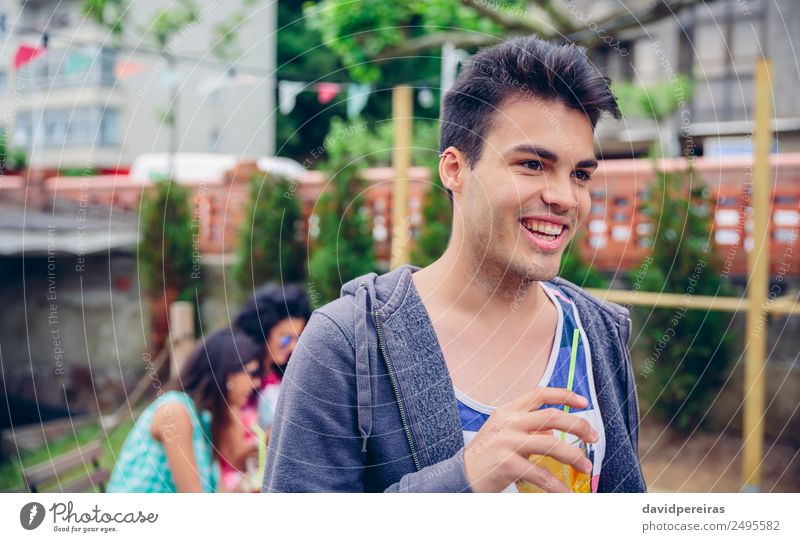 Young man holding glass of infused water cocktail outdoors Fruit Beverage Juice Lifestyle Joy Happy Leisure and hobbies Summer Garden Table Human being Woman