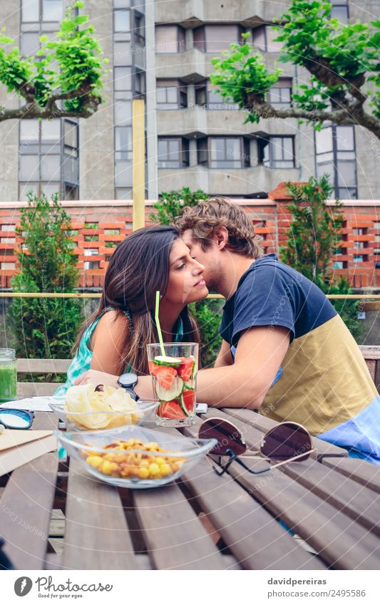 Young man whispering to woman sitting outdoors Vegetable Fruit Beverage Lifestyle Joy Happy Leisure and hobbies Summer Garden Table Human being Woman Adults Man