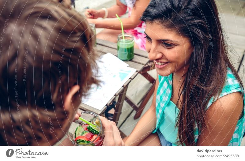 Smiling woman looking man drinking infused water cocktail Vegetable Fruit Beverage Drinking Lifestyle Joy Happy Leisure and hobbies Summer Garden Table