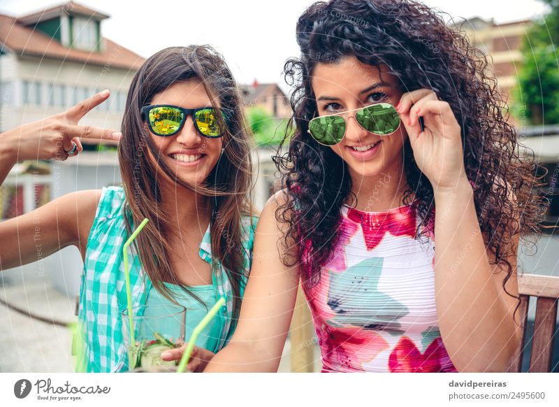 Two women with sunglasses and smoothies looking at camera Vegetable Fruit Beverage Juice Lifestyle Joy Happy Leisure and hobbies Summer Success Human being