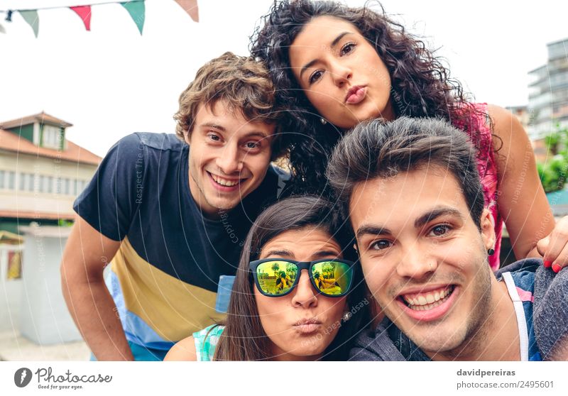 Young happy people looking at camera in a summer party outdoors Lifestyle Joy Happy Leisure and hobbies Vacation & Travel Summer Feasts & Celebrations Camera