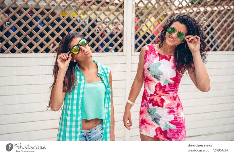 Women with sunglasses looking at camera over garden fence Lifestyle Joy Happy Face Leisure and hobbies Summer Garden Mirror Human being Woman Adults Friendship