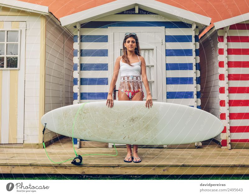 Young surfer woman with top and bikini holding surfboard Lifestyle Joy Happy Beautiful Leisure and hobbies Vacation & Travel Summer Beach Ocean Garden Sports