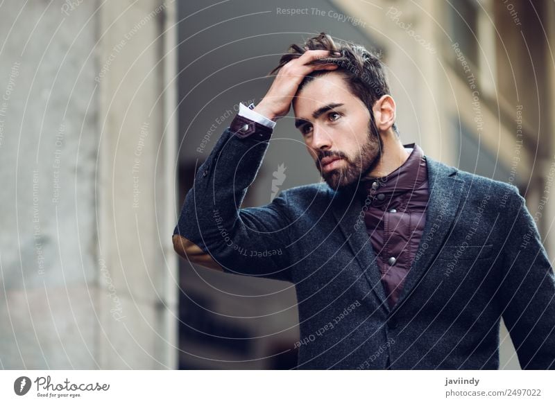 Young Man Wearing Winter Clothes In The Street. Stock Photo, Picture and  Royalty Free Image. Image 124791224.