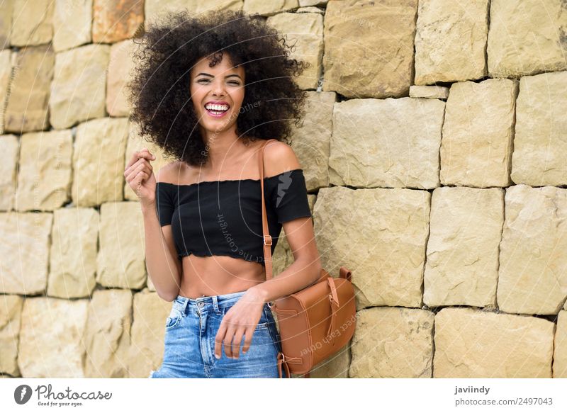 Happy mixed woman with afro hair laughing outdoors Lifestyle Style Joy Hair and hairstyles Human being Feminine Young woman Youth (Young adults) Woman Adults 1