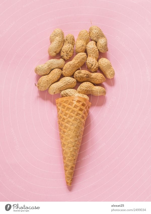 Ice cream cone with unpeeled peanuts on pink background Food Dessert Nutrition Fresh Natural ice Ingredients isolated Organic Peanut Photography Snack sweet
