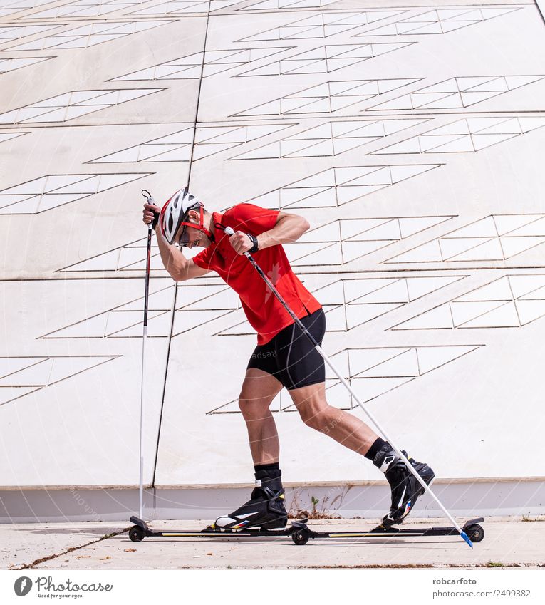A young man cross-country skiing with roller ski Lifestyle Style Leisure and hobbies Summer Mountain Sports Skiing Skis Man Adults Nature Landscape Park Street