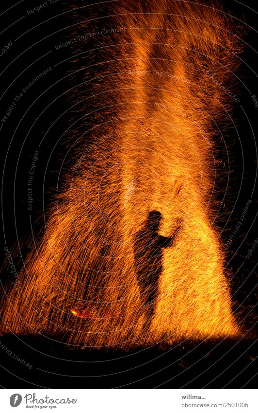 Man stands in a shower of sparks Fire Human being Silhouette Hot Threat Spark Burn Blaze Flame Dangerous Arson Copy Space bottom Night Elements