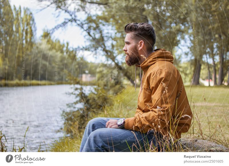 Man sitting by the river in fall Lifestyle Human being Masculine Young man Youth (Young adults) Body 1 18 - 30 years Adults Nature Landscape Water Autumn Tree