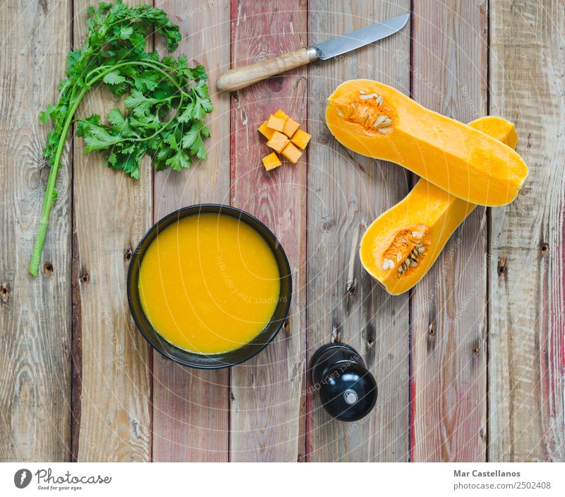 Pumpkin soup in ceramic black bowl Vegetable Soup Stew Herbs and spices Eating Lunch Dinner Vegetarian diet Diet Plate Bowl Knives Wellness Kitchen Autumn