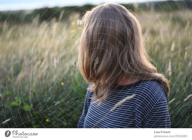 Blond woman sitting in a field. Young woman Youth (Young adults) 1 Human being 18 - 30 years Adults Environment Nature Landscape Beautiful weather Bushes Meadow