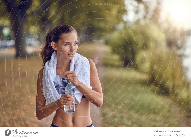 Fit sporty woman holding a bottle of water Bottle Sports Woman Adults 1 Human being 18 - 30 years Youth (Young adults) Park Fitness Running Athletic training