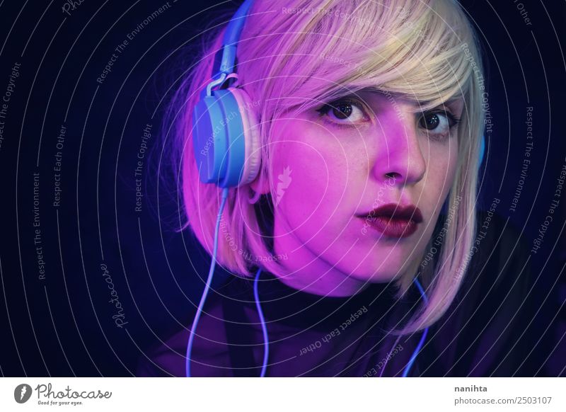 Portrait of a blonde young woman listening to music Lifestyle Style Design Beautiful Hair and hairstyles Face Leisure and hobbies Headset Headphones Technology